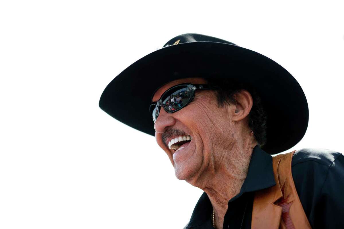 In this Saturday, June 10, 2017, photo, Richard Petty smiles while talking with fans at a sponsor's event during the NASCAR Cup Series Pocono 400 auto race weekend in Long Pond, Pa. Petty said Sunday that anyone on his team who protested the national anthem would be fired.
