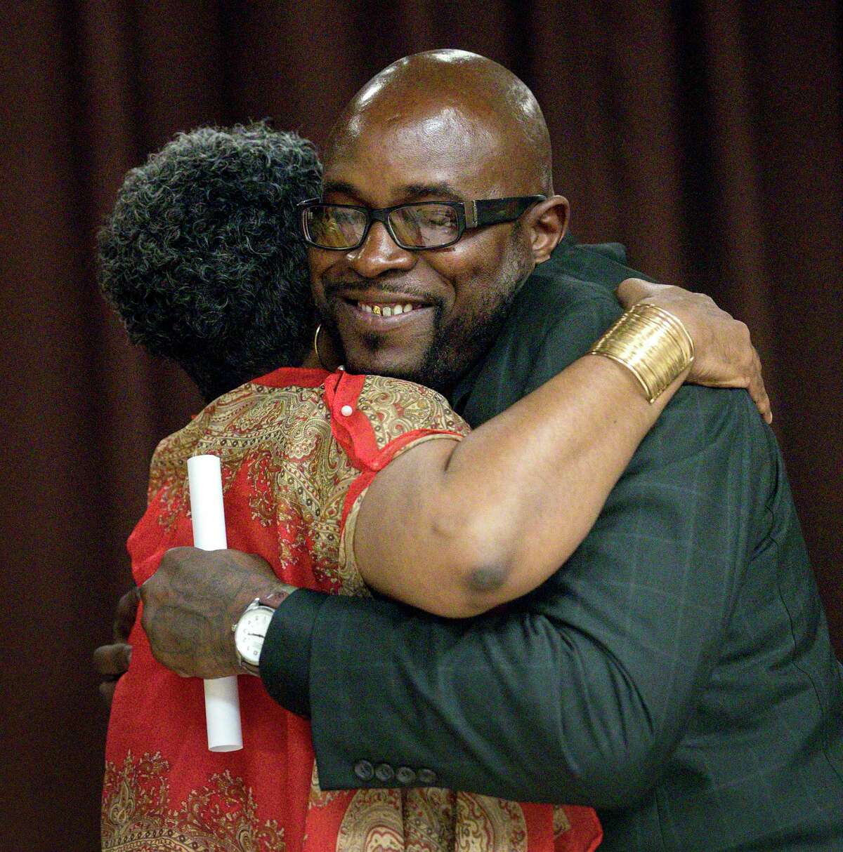 Joseph Dowell, right, also known as "Unc," hugs Jennifer Herring, director of re-entry services at the Harris County Sheriff's Office, during a graduation ceremony for the Community Re-Entry Network Program, Thursday, May 18, 2017, in Houston. While in jail, Dowell was part of the "Freedom Project," which aims to help inmates struggling with addiction. After his release, he began working with the CRNP, and he will start a job with the City of Houston in a few weeks. ( Jon Shapley / Houston Chronicle )