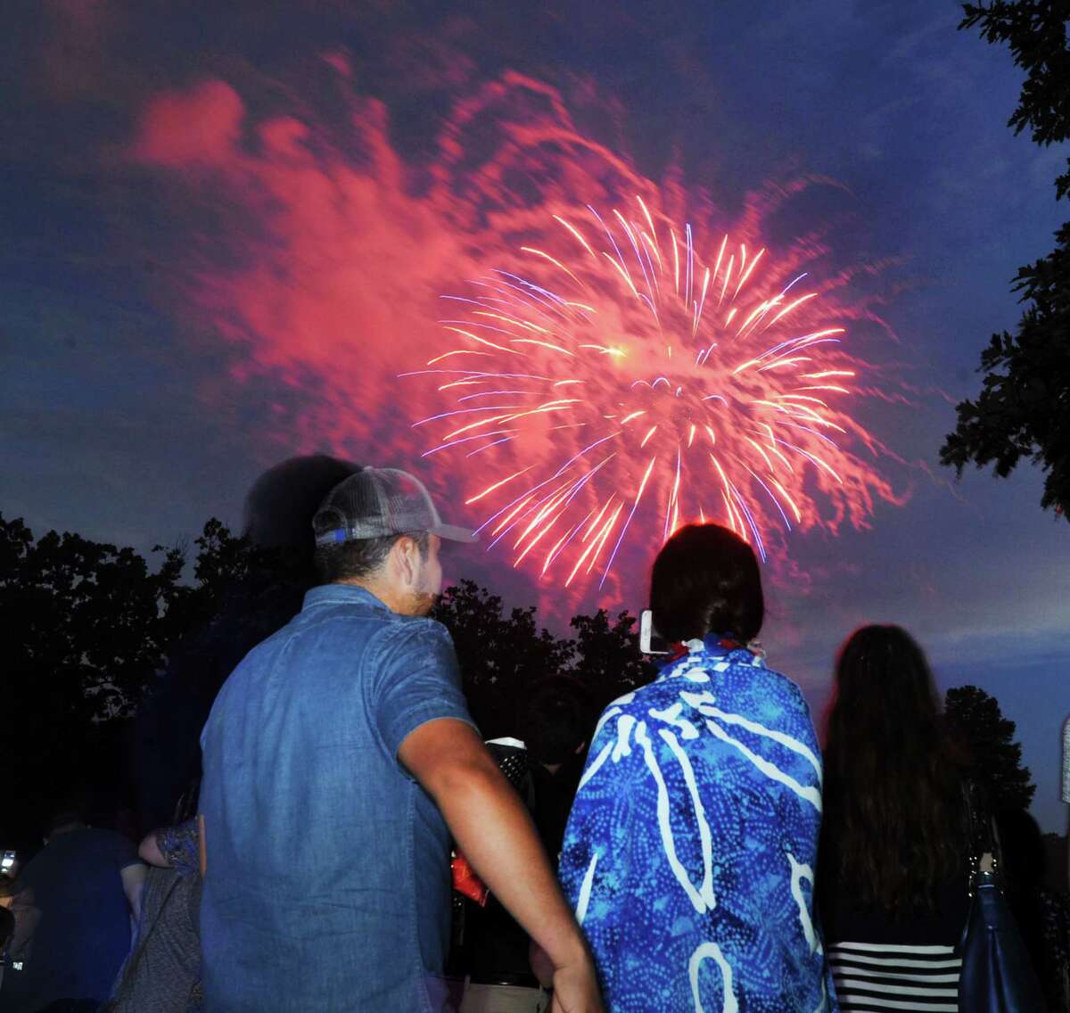 Spectators watch the annual Town of Greenwich fireworks display at Binney Park in Old Greenwich, Conn., Saturday, July 1, 2017.