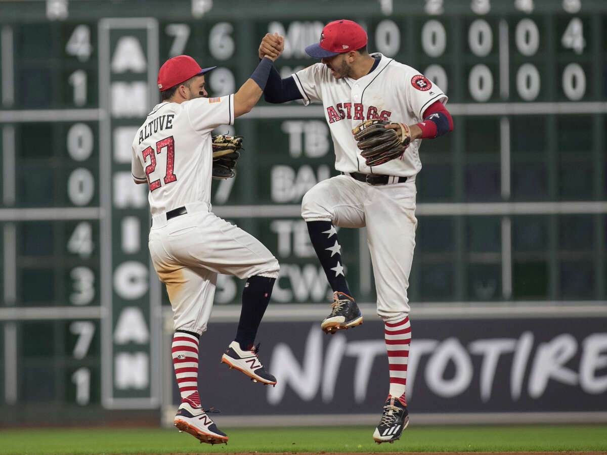 Houston Astros players Jose Altuve (27) and Carlos Correa (1) celebrate the team's win over New York Yankees after the game at Minute Maid Park Saturday, July 1, 2017, in Houston. Houston Astros defeated New York Yankees 7-6. ( Yi-Chin Lee / Houston Chronicle )