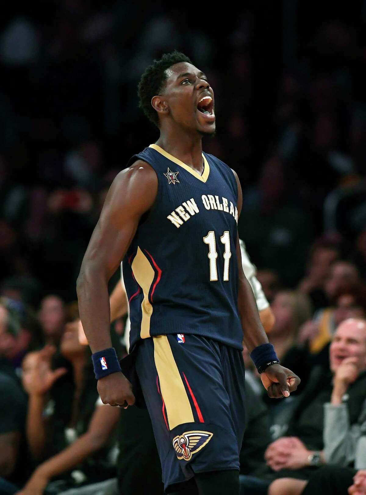 FILE - In this March 5, 2017 file photo, New Orleans Pelicans guard Jrue Holiday celebrates after scoring during the second half of an NBA basketball game against the Los Angeles Lakers. Point guards are cashing in so far in NBA free agency, teams have already paid nearly a half-billion dollars in commitments to five and Day 1 is still a long way from complete. Holiday is among the early cashers-in and has agreed to terms on a new five-year, $126 million deal with the New Orleans Pelicans. (AP Photo/Mark J. Terrill, File) ORG XMIT: NYCD903