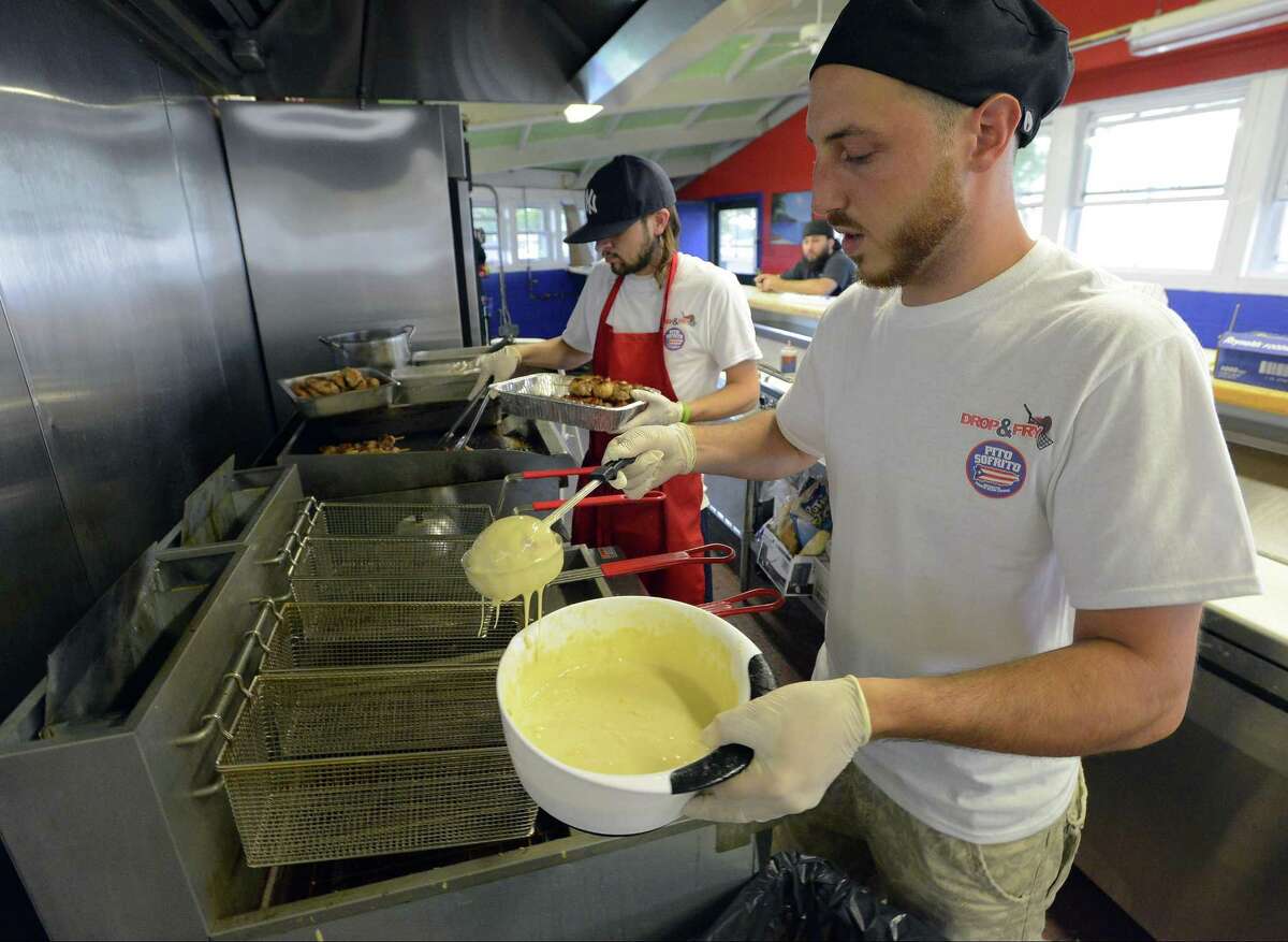 Tyler Burchard, manager of Drop & Fry, prepares an order of Fried Ice Cream for a customer of the new concession at Cummings Beach in Stamford, Conn., on Friday, June 23, 2017.