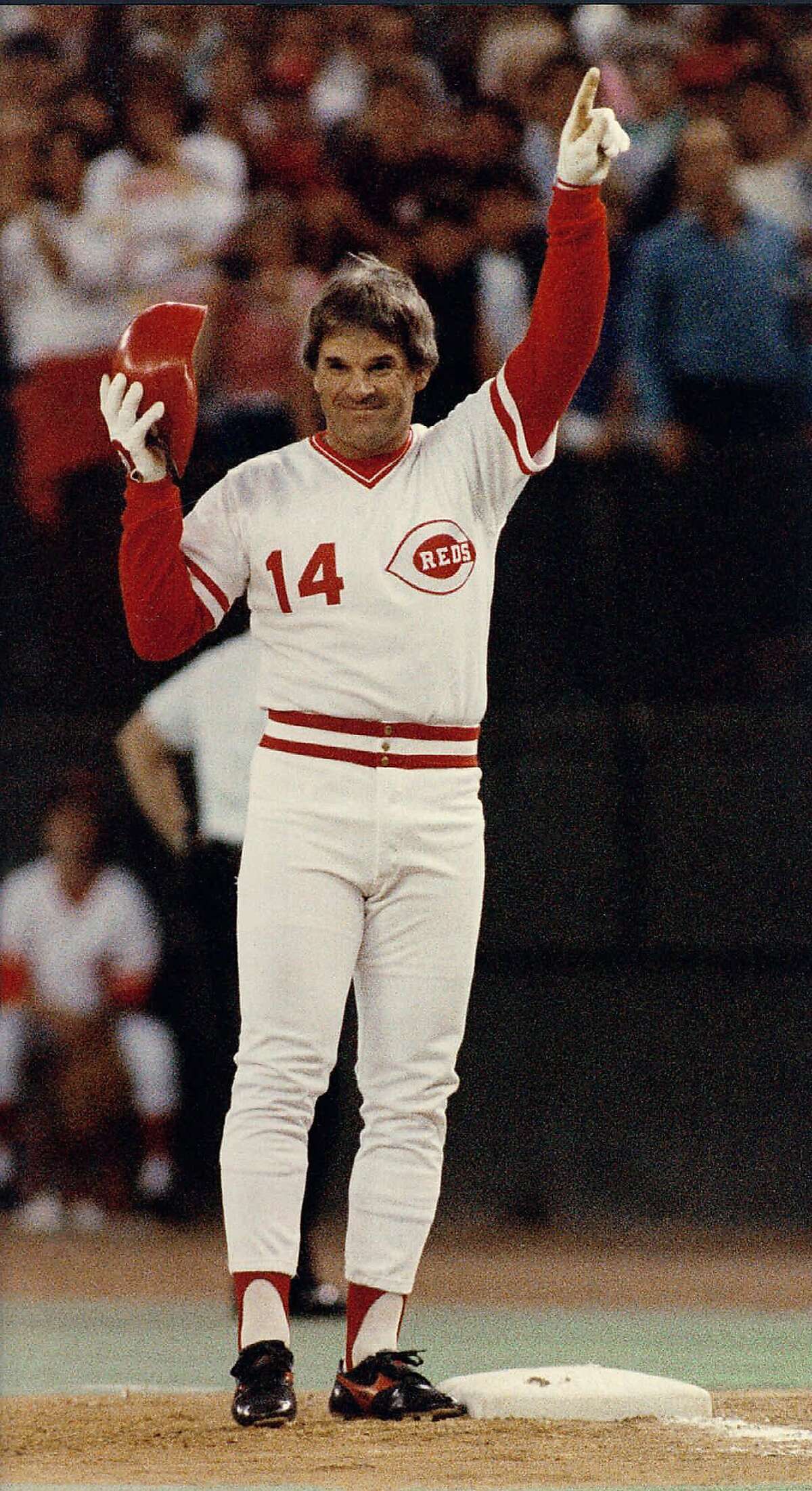 ** FILE ** Cincinnati Reds Pete Rose signals he's #1 after connecting for his 4,192nd career base hit to break Ty Cobb's all-time record in this Sept. 11, 1985 photo in Cincinnati. A 17-time All-Star and former National League MVP, Rose agreed to a lifetime ban from baseball in August 1989 following an investigation of his gambling but has maintained he never bet on baseball. Rose and commissioner Bud Selig met secretly in Milwaukee on Nov. 25, 2002, and their lawyers have been exchanging draft proposals that could end the ban, a baseball executive said Tuesday, Dec. 10, 2002, on the condition he not be identified. (AP Photo/Bill Waugh)