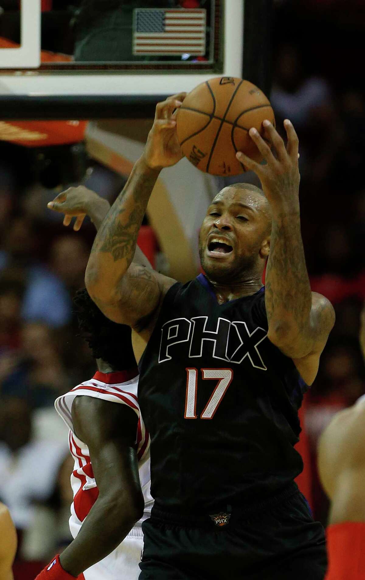 Phoenix Suns forward P.J. Tucker (17) grabs a rebound during the second half of an NBA basketball game at Toyota Center, Thursday, April 7, 2016, in Houston. Rockets lost to Phoenix 124-115. ( Karen Warren / Houston Chronicle )
