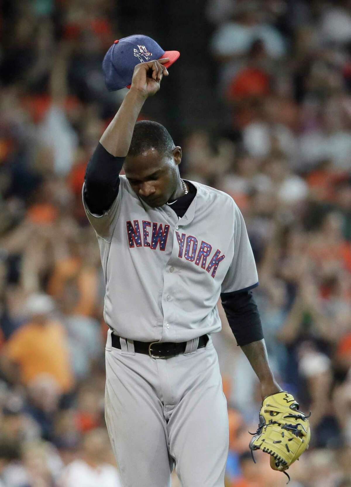 New York Yankees starting pitcher Domingo German wipes his head after giving up a two-run home run to Houston Astros' Yuli Gurriel during the seventh inning of a baseball game, Sunday, July 2, 2017, in Houston. (AP Photo/David J. Phillip)