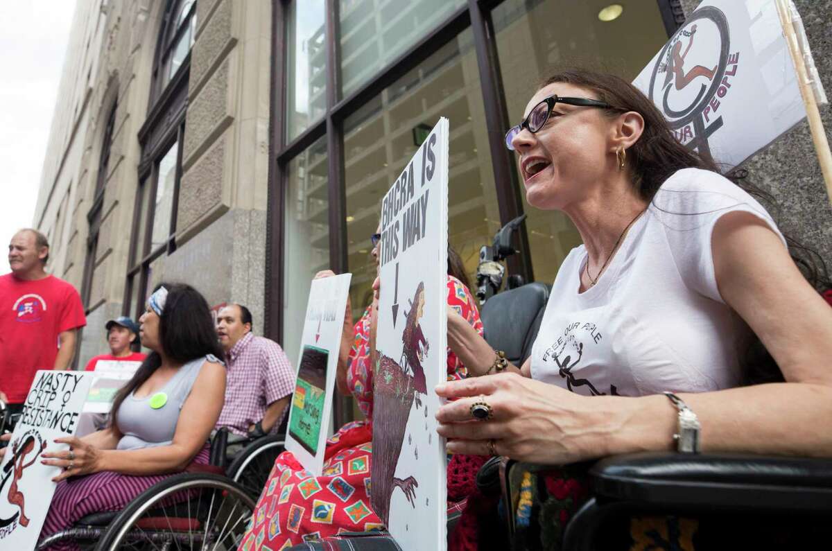Lydia Nunez Landry, right, chants alongside fellow members of ADAPT, American Disabled Attendant Programs Today, during a demonstration to protest current GOP health care plans outside the building where Senator Ted Cruz's office is located Wednesday, June 28, 2017, in Houston. ( Godofredo A. Vasquez / Houston Chronicle )