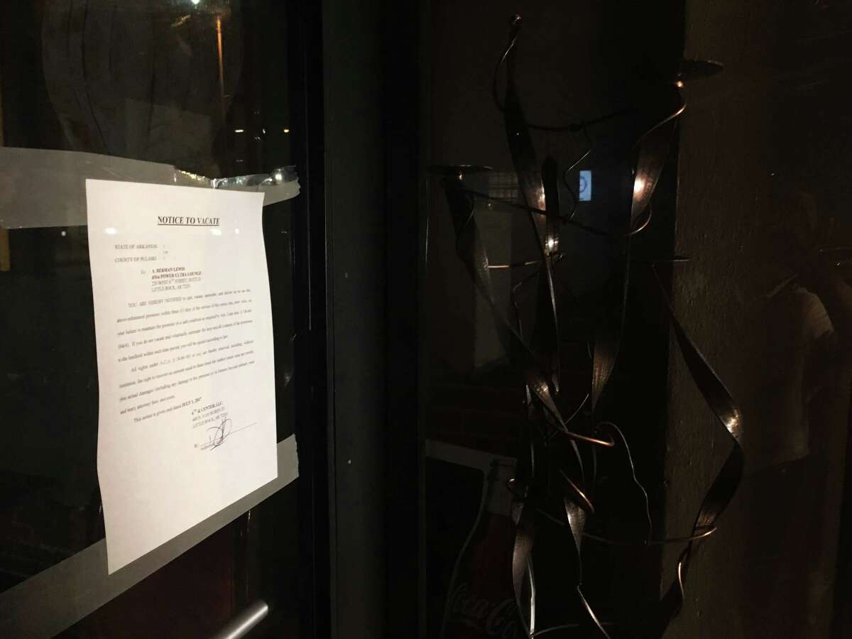 An eviction notice is posted on a door to the Pulse Ultra Lounge in Little Rock, Ark., Saturday, July 1, 2017. City officials said they would take steps to shut the club down after a shooting during a rap concert earlier Saturday left more than two dozen people injured. A representative of the club's landlord posted the notice on a glass door facing a city sidewalk Saturday night. (AP Photo/Kelly P. Kissel)