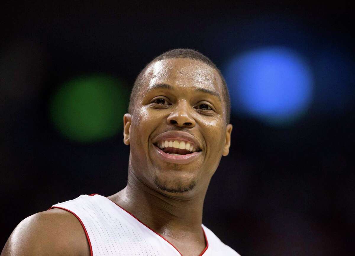 FILE - In this April 9, 2014 file photo, Toronto Raptors guard Kyle Lowry (7) smiles at the crowd late in second half NBA action against the Philadelphia 76ers in Toronto. The Raptors have re-signed Lowry to a multiyear contract. The deal was agreed to last week but couldn't be made official until Thursday, July 10, 2014, when the NBA's moratorium on free-agent signings ended. Terms weren't disclosed, but Yahoo Sports had reported it was for $48 million over four years. (AP Photo/The Canadian Press, Peter Power, File)