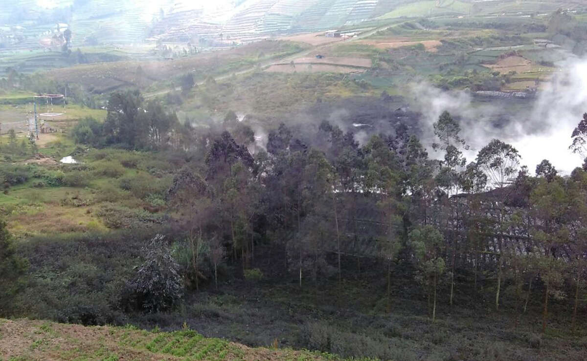 Smoke billows from Sileri Crater after it erupted in Dieng, Central Java, Indonesia, Sunday, July 2, 2017. A helicopter carrying eight people crashed Sunday while on the way to help with evacuations near a volcano that erupted on the main Indonesian island of Java. (AP Photo/Dwiana Jati Setiaji)