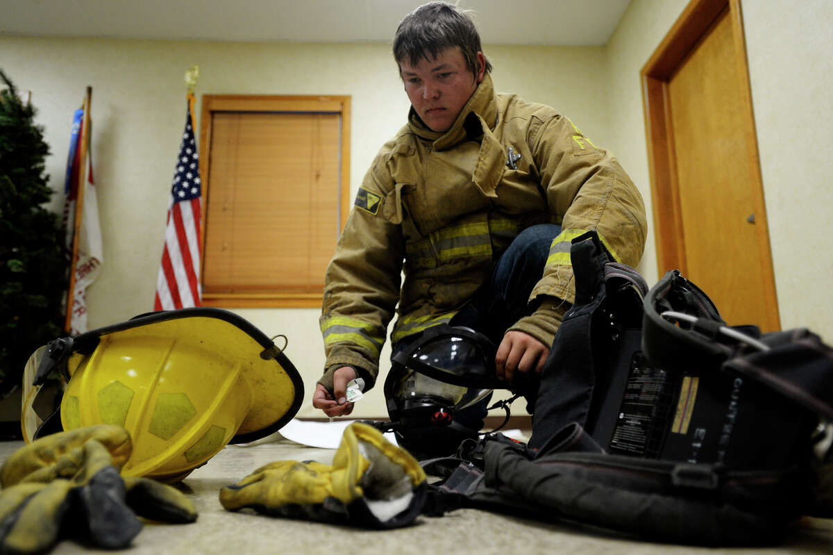 Justin Sticker, 18, practices putting on his fire gear at the Kountze Volunteer Fire Department on Monday evening. Sticker joined the department after firefighters helped him following a Nov. 12, 2014 car wreck that left him severely injured. Photo taken Monday 6/26/17 Ryan Pelham/The Enterprise