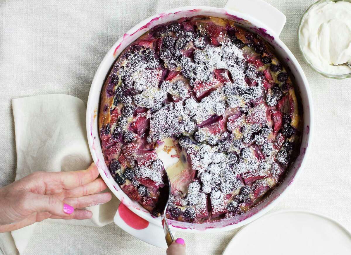 This June 1, 2017 photo shows a berry clafoutis in New York. This dish is from a recipe by Katie Workman. (Sarah E Crowder via AP)
