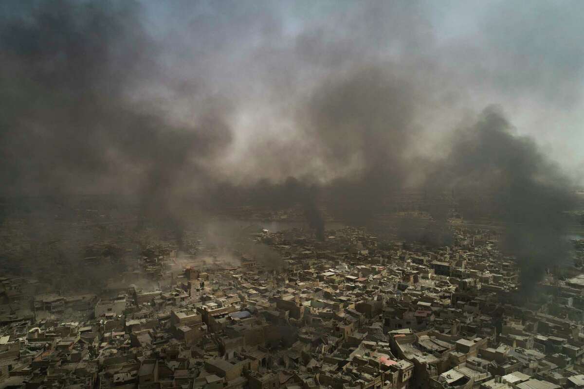 Smoke billows over the Old City after several strikes as Iraqi forces continue their advance against Islamic State militants in Mosul, Iraq, Monday, July 3, 2017. (AP Photo/Felipe Dana)
