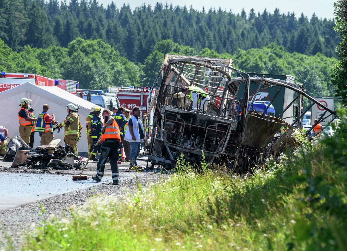 Police experts work at the place of an accident on the motorway A9. near Muenchberg, Germany, Monday, July 3, 2017. Several people are feared dead after a bus carrying a group of German senior citizens crashed into a truck on a highway in Bavaria early Monday and burst into flames. (Matthias Balk/dpa via AP)
