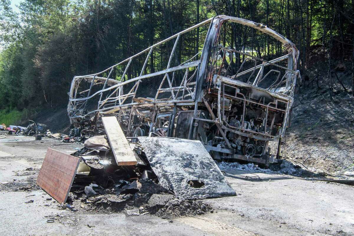 The wreckage of a burnt-out bus photographed at the place of an accident on the motorway A9. near Muenchberg, Germany, Monday, July 3, 2017. Several people are feared dead after a bus carrying a group of German senior citizens crashed into a truck on a highway in Bavaria early Monday and burst into flames, police said. (Matthias Balk/dpa via AP)