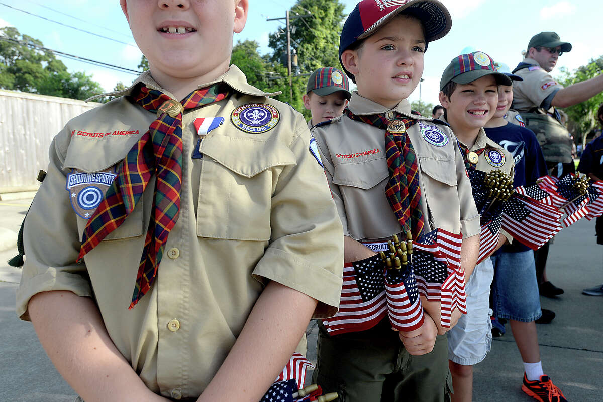 Cub Scouts with Pack 122 are loaded with flags to pass out to spectators as they await the start of the annual 1929 Calder Place Fourth of July Parade Tuesday morning. Participants and spectators alike were encouraged to don their red, white, and blue attire for the event, kicking off a day and night of holiday celebration. Prizes for best dressed and best decorated cars, bikes, and floats followed the parade. Photo taken Tuesday, July, 4, 2017 Kim Brent/The Enterprise