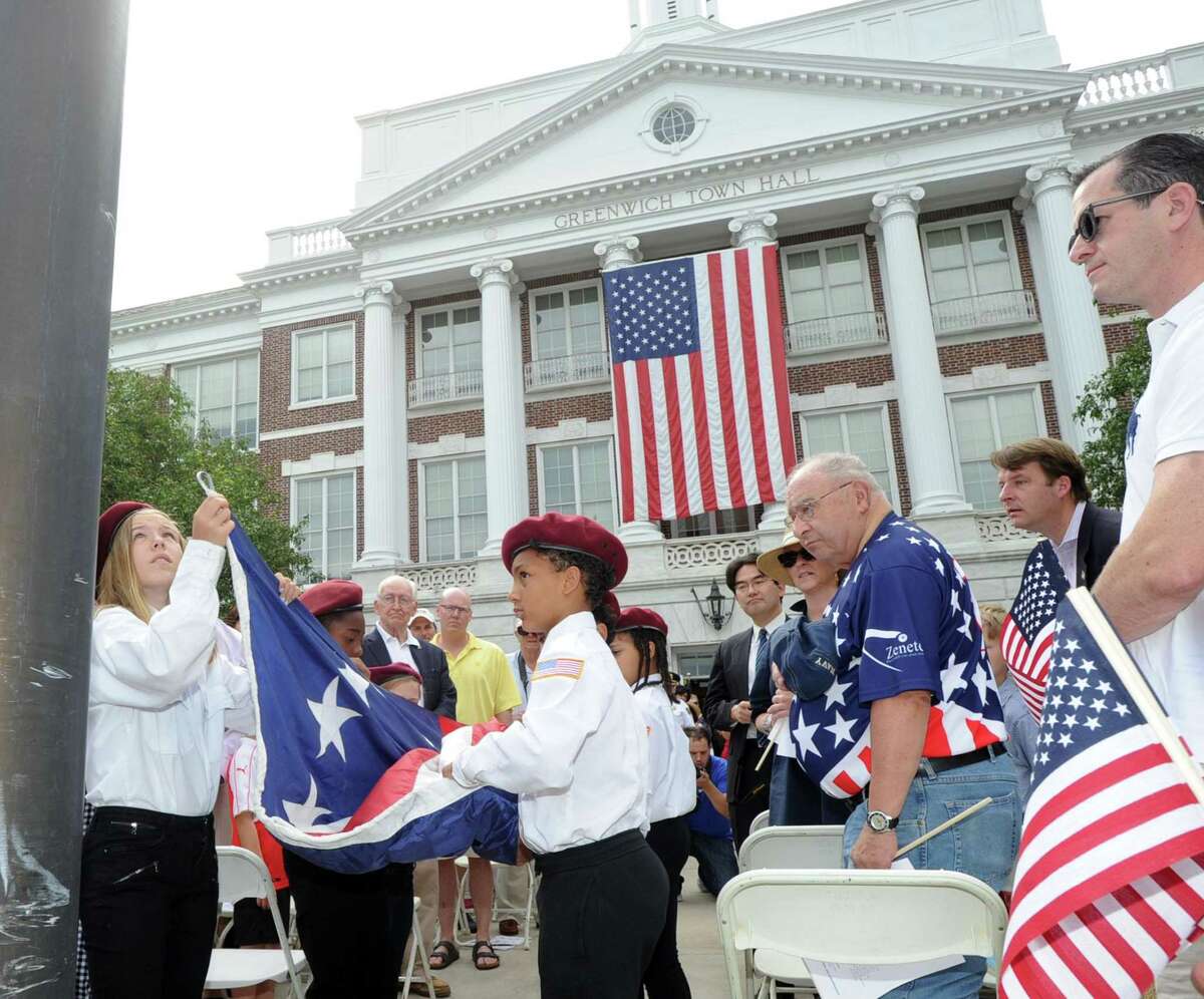 The Boys & Girls Club of Greenwich Honor Guard lead by Minnetta Arlotti, 11, left, raised the American Flag during the Fourth of July ceremony at Greenwich Town Hall, Greenwich, Conn., Tuesday morning, July 4th, 2017.