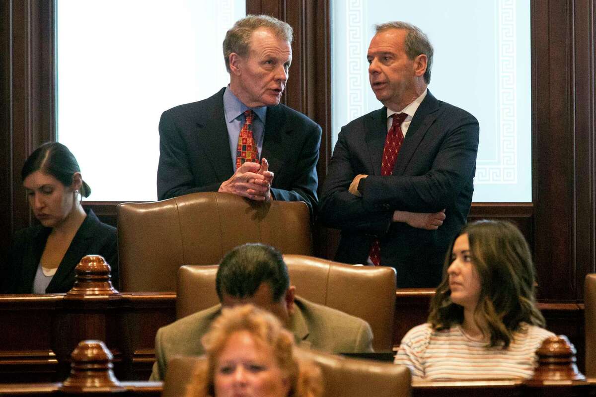 House Speaker Michael Madigan, D-Chicago, left, and Senate President John Cullerton, D-Chicago, talk on the Senate floor Tuesday, July 4, 2017, at the Capitol in Springfield, Ill. The Illinois Senate has OK'd an annual spending plan of $36 billion following a critical vote to raise the income tax rate. If approved by Republican Gov. Bruce Rauner, it would be Illinois' first budget in more than two years. (Rich Saal/The State Journal-Register via AP)
