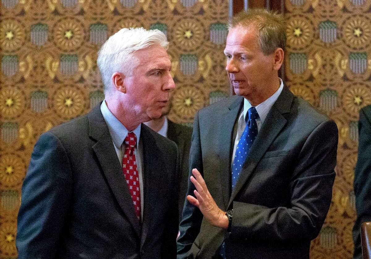 Sen. Dale Righter, R-Mattoon, right, talks with Sen. Michael Connelly, R-Naperville, Tuesday, July 4, 2017, on the Senate floor at the Capitol in Springfield, Ill. The Illinois Senate has OK'd an annual spending plan of $36 billion following a critical vote to raise the income tax rate. If approved by Republican Gov. Bruce Rauner, it would be Illinois' first budget in more than two years. (Rich Saal/The State Journal-Register via AP)