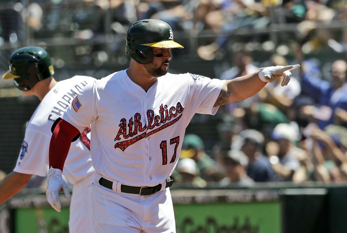 Oakland Athletics' Yonder Alonso points to the dugout after hitting a two-run home run against the Chicago White Sox in the fifth inning of a baseball game Tuesday, July 4, 2017, in Oakland, Calif. (AP Photo/Marcio Jose Sanchez)
