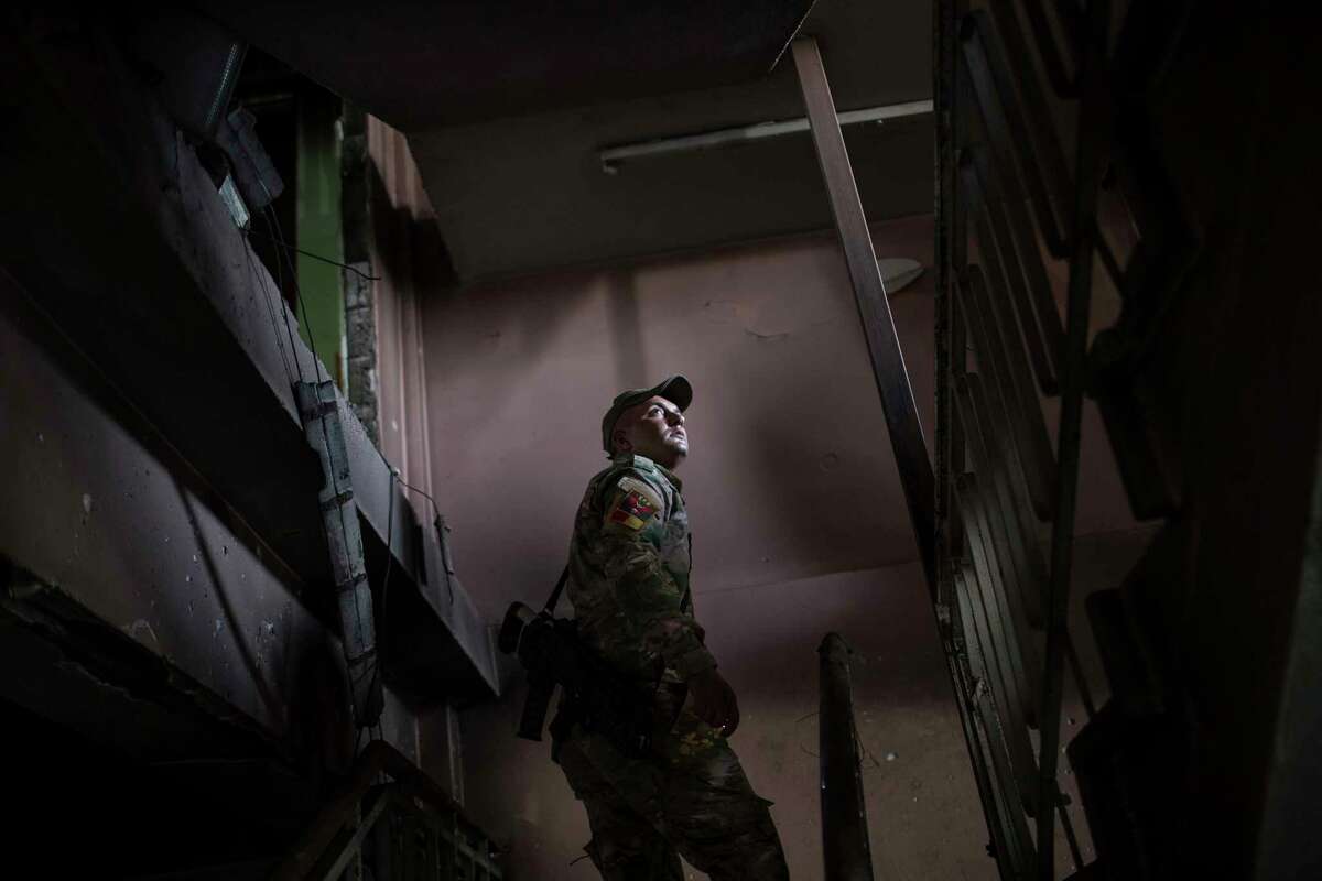 A Federal Police Rapid Response Force fighter walks inside a building at Mosul's main hospital complex after it was retaken by Iraqi forces during fighting against Islamic State militants, in Mosul, Iraq, Tuesday, July 4, 2017. (AP Photo/Felipe Dana)