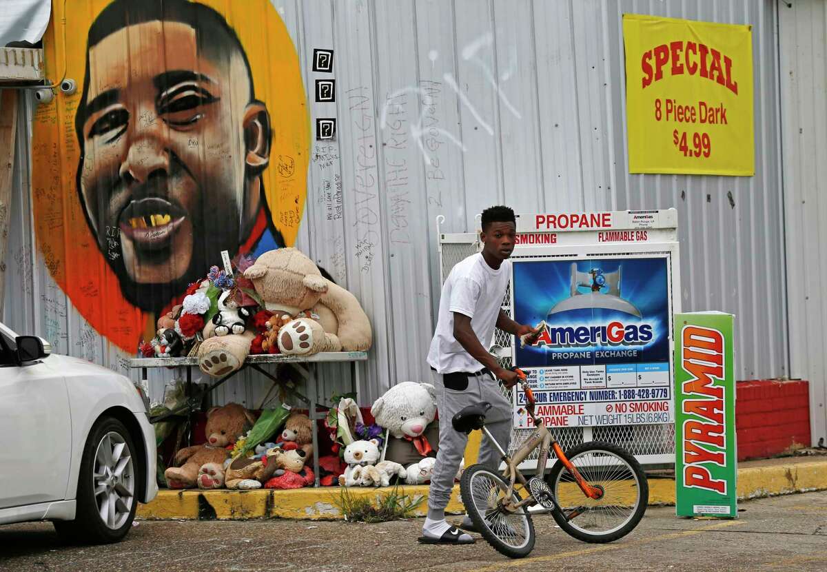 Ronald Smith stops by ﻿the iconic mural of Alton Sterling on the side of Triple S Food Mart ﻿in Baton Rouge, La., one year after Alton was shot by police in the same parking lot. ﻿