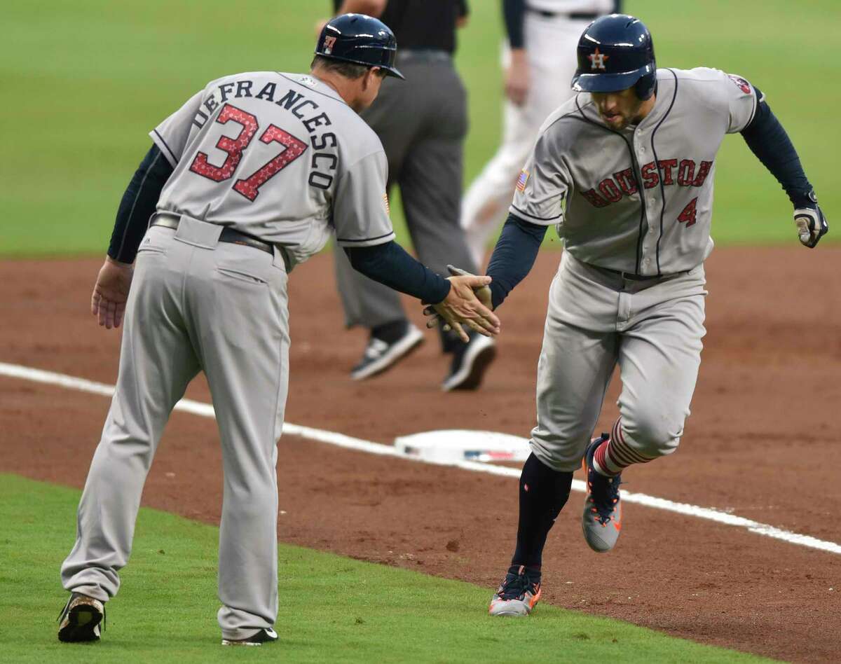 Substitute third-base coach Tony DeFrancesco, left, was a busy man Tuesday night as the Astros racked up the runs, including a third-inning home run by George Springer for his 25th of the season.