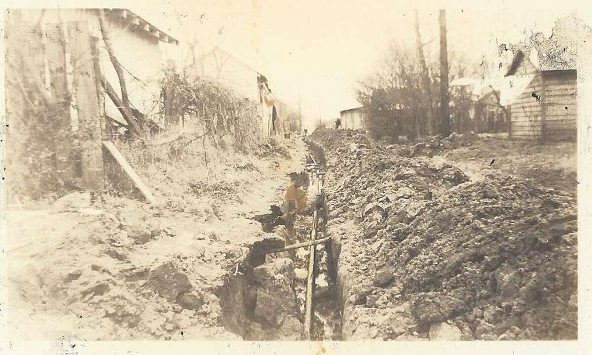 The photo is circa 1938 when a natural gas line was being dug by hand in Conroe.
