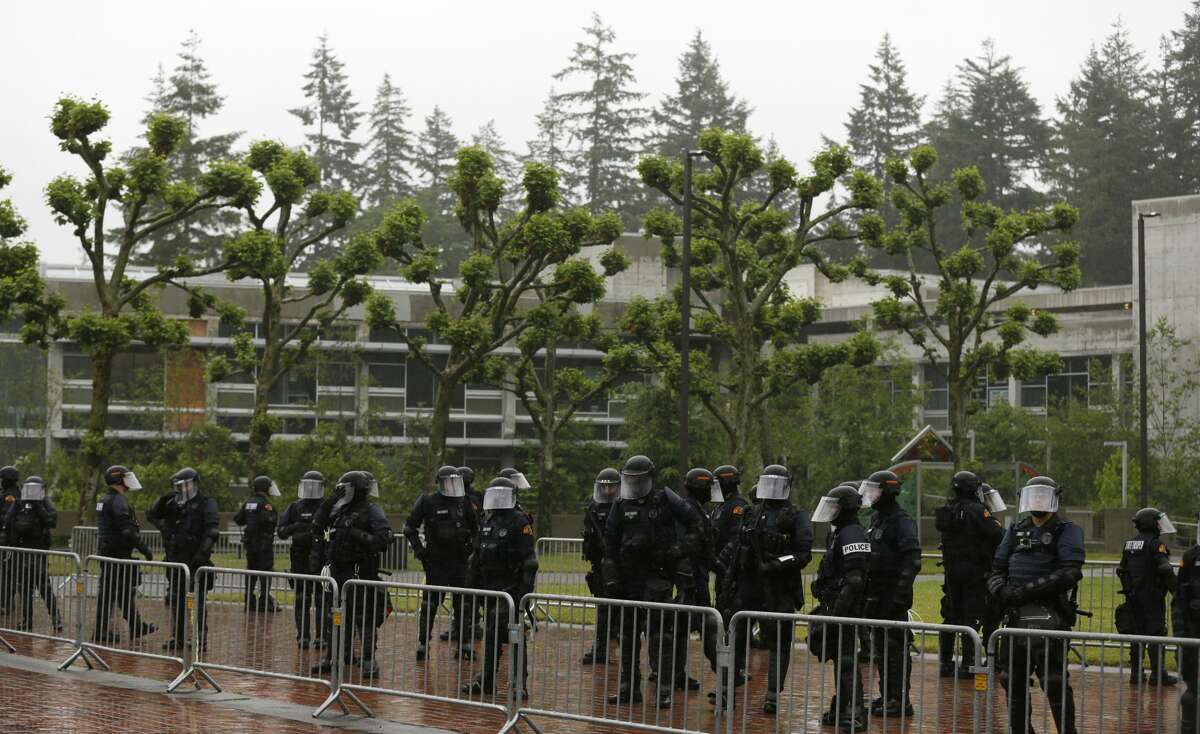Washington State Troopers stand on campus before a protest by the conservative group Patriot Prayer, Thursday, June 15, 2017, at The Evergreen State College in Olympia, Wash. (AP Photo/Ted S. Warren)