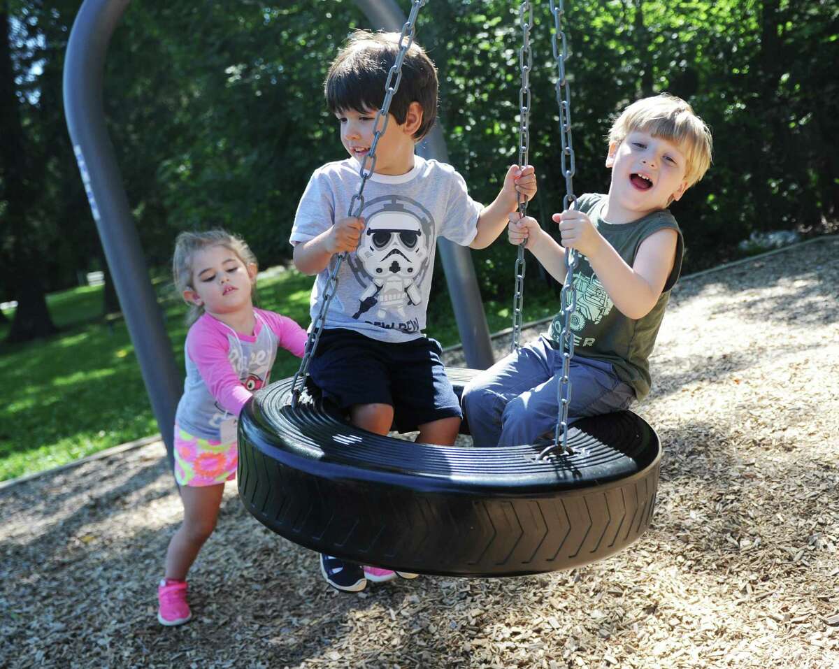 Ava Mohrin pushes fellow pre-K students on a tire swing during recess on the first day of pre-K summer school at North Street School Wednesday.
