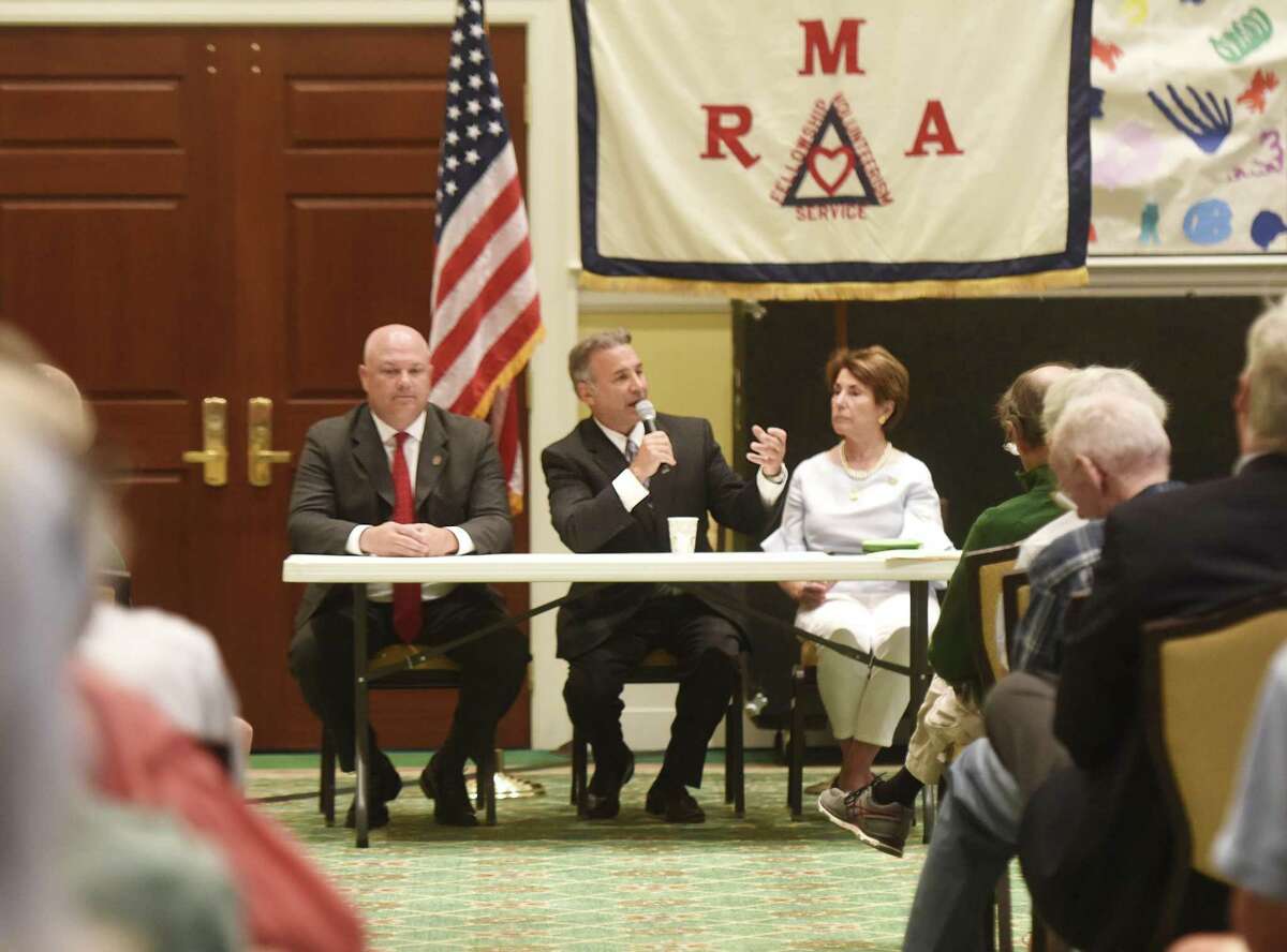 State Representatives Mike Bocchino, left, Fred Camillo and Livvy Floren speak during the Retired Men's Association's weekly speaker series at First Presbyterian Church in Greenwich, Conn. Wednesday, July 5, 2017. The three legislators gave an update on the Connecticut budget and answered questions from the audience.