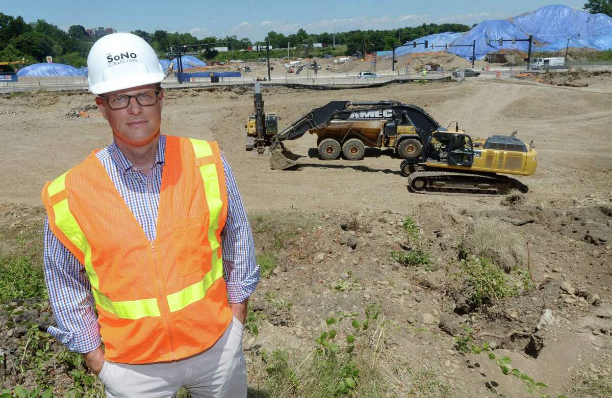 General Growth Properties Senior Director Doug Adams at The SoNo Collection construction site Wednesday off West Avenue, North Water Street and Interstate 95 in Norwalk. GGP on Wednesday obtained nearly $1 million in superstructure permits from the Norwalk Building Department to begin vertical construction on The SoNo Collection. Major excavation work continues on the dozen-acre development site with earth heaped high and being trucked away to create space for the foundation and below-grade parking levels.