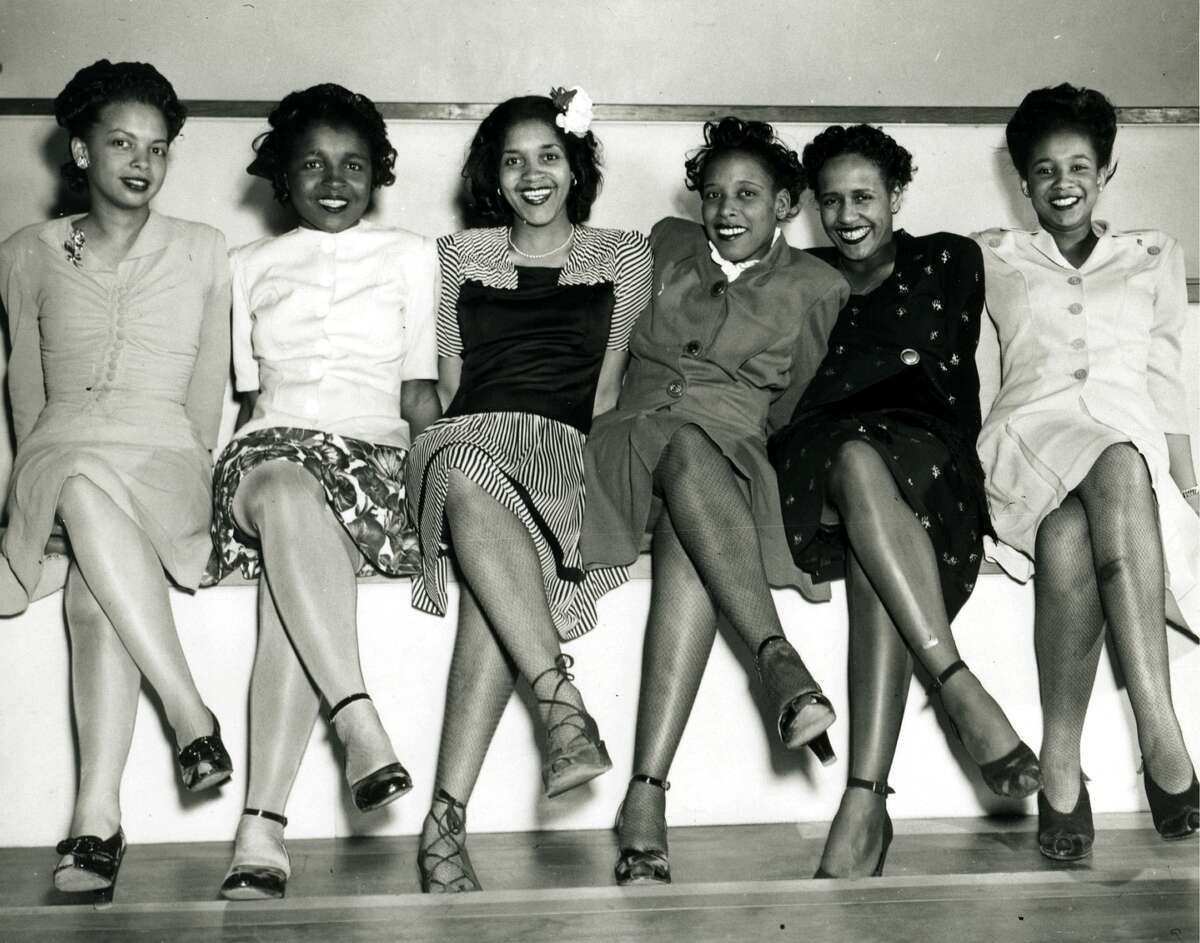 Group portrait of pin-up girls smiling while attending the Spring Formal Dance at the Naval Air Station in Seattle, WA, April 1944. (Photo by PhotoQuest/Getty Images)