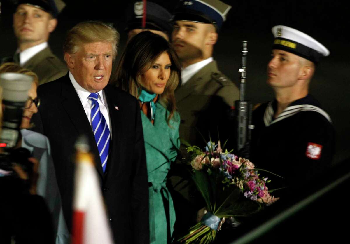 President Trump, right and the first lady Melania Trump walk past the honor guards as they arrive to Warsaw, Poland, Wednesday, July 5, 2017. President Donald Trump is back to Europe hoping to receive a friendly welcome in Poland despite lingering skepticism across the continent over his commitment to NATO, his past praise of Russian President Vladimir Putin and his decision to pull the U.S. out of a major climate agreement. (AP Photo/Czarek Sokolowski)