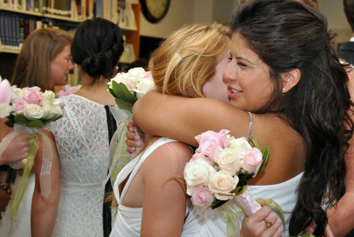 Alexandra Flecha-Hirsch, of Weston, hugs a classmate in the library before the Greens Farms Academy eighty-fifth commencement on Thursday, June 10, 2010.