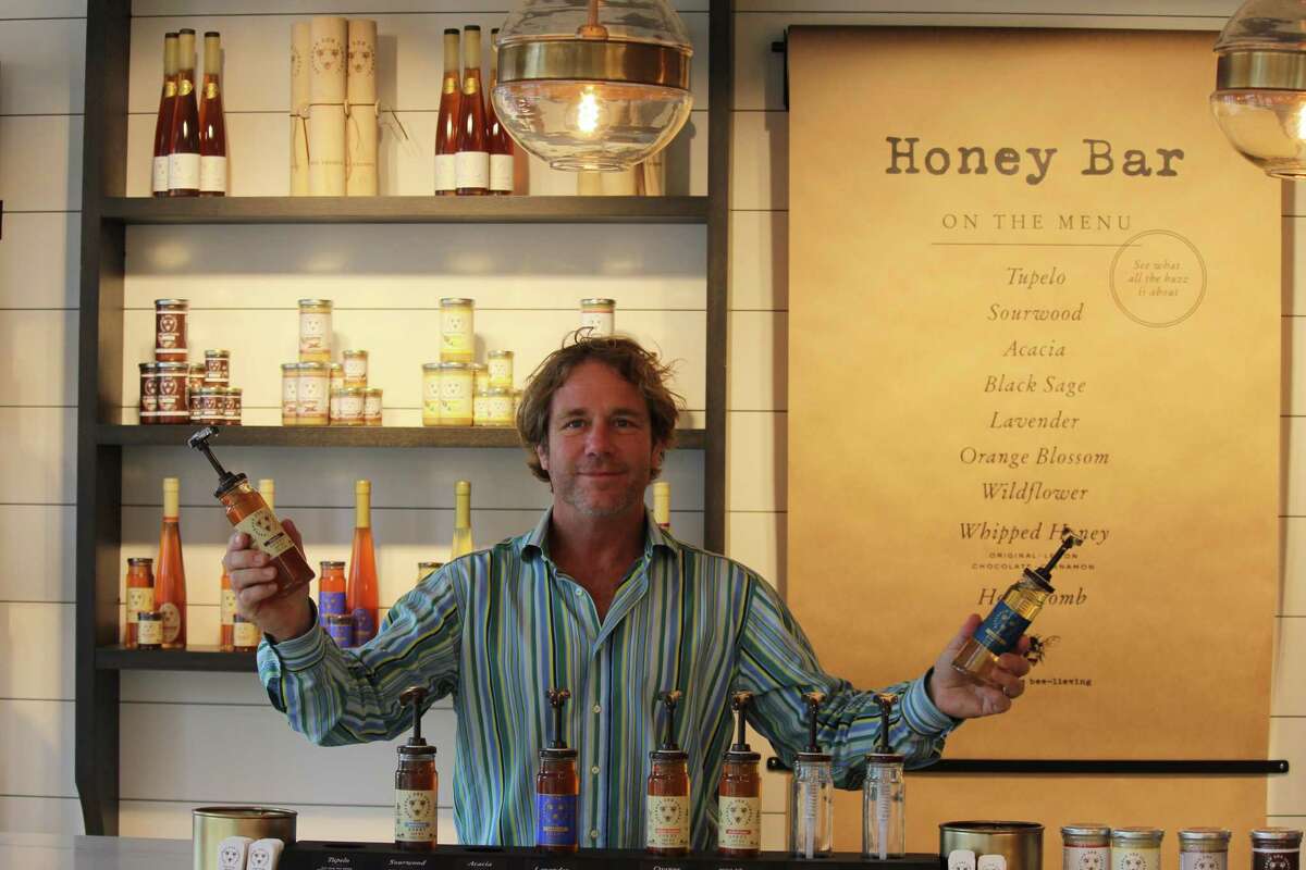 Ted Dennard, president and founder of Savannah Bee Company, poses at the honey bar of his store's new Bedford Square location on Church Lane.