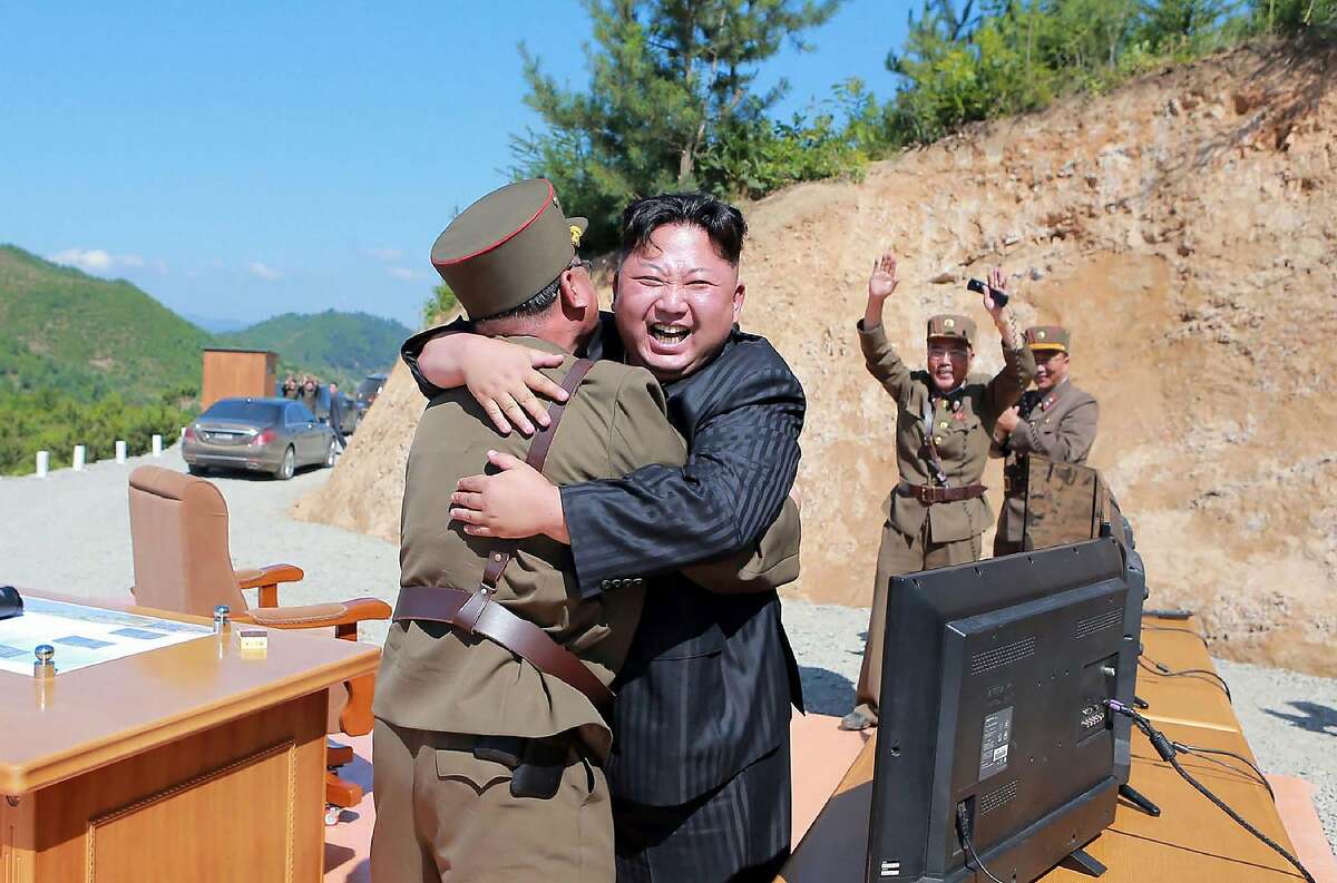 TOPSHOT - This picture taken on July 4, 2017 and released by North Korea's official Korean Central News Agency (KCNA) on July 5, 2017 shows North Korean leader Kim Jong-Un (C) celebrating the successful test-fire of the intercontinental ballistic missile Hwasong-14 at an undisclosed location. South Korea and the United States fired off missiles on July 5 simulating a precision strike against North Korea's leadership, in response to a landmark ICBM test described by Kim Jong-Un as a gift to "American bastards". / AFP PHOTO / KCNA VIA KNS / STR / South Korea OUT / REPUBLIC OF KOREA OUT ---EDITORS NOTE--- RESTRICTED TO EDITORIAL USE - MANDATORY CREDIT "AFP PHOTO/KCNA VIA KNS" - NO MARKETING NO ADVERTISING CAMPAIGNS - DISTRIBUTED AS A SERVICE TO CLIENTS THIS PICTURE WAS MADE AVAILABLE BY A THIRD PARTY. AFP CAN NOT INDEPENDENTLY VERIFY THE AUTHENTICITY, LOCATION, DATE AND CONTENT OF THIS IMAGE. THIS PHOTO IS DISTRIBUTED EXACTLY AS RECEIVED BY AFP. / STR/AFP/Getty Images