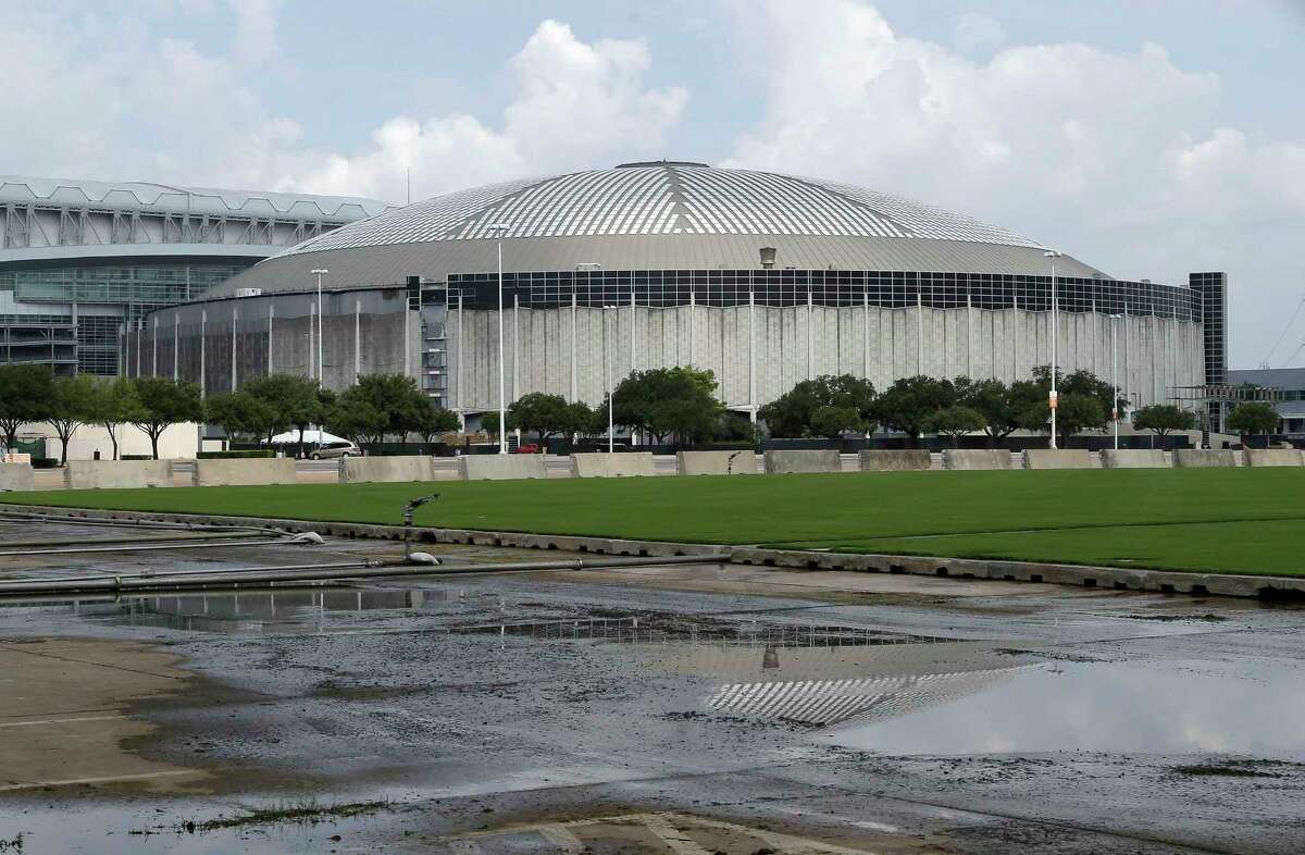 FILE - In this July 30, 2014, file photo, the Houston Astrodome is reflected in a puddle in Houston. The Texas Historical Commission voted Friday, Jan. 27, 2017, to grant landmark status to the no-longer-used enclosed stadium amid plans to redevelop the no-longer-used enclosed stadium. (AP Photo/Pat Sullivan, File)