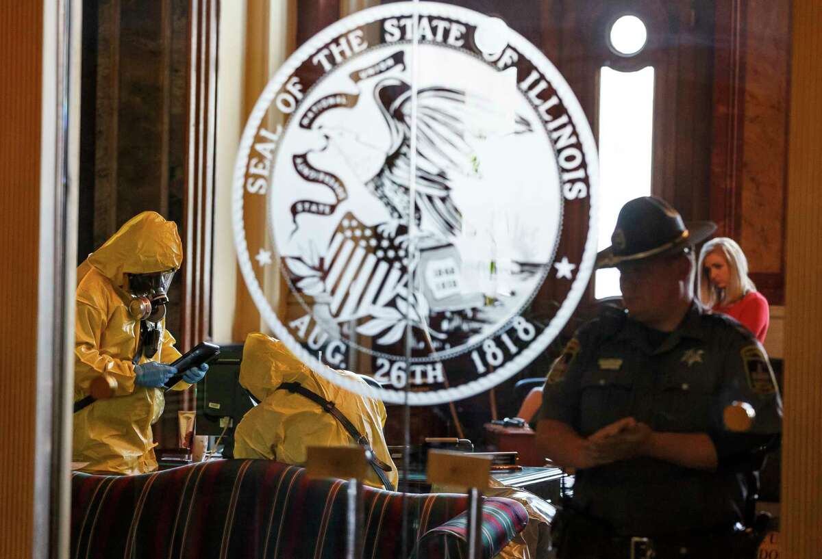 The Springfield Fire Dept. and the Hazardous Materials Unit test the Governor's office with the building on lockdown after a woman threw a powdery substance in the office during the overtime session at the Illinois State Capitol, Thursday, July 6, 2017, in Springfield, Ill. A financial showdown more than two years in the making was slated to play out in the Illinois House on Thursday as Democrats try to enact a $36 billion spending plan fueled by a 32 percent income tax increase over the Republican governorÂ?’s objection. [Justin L. Fowler/The State Journal-Register via AP)