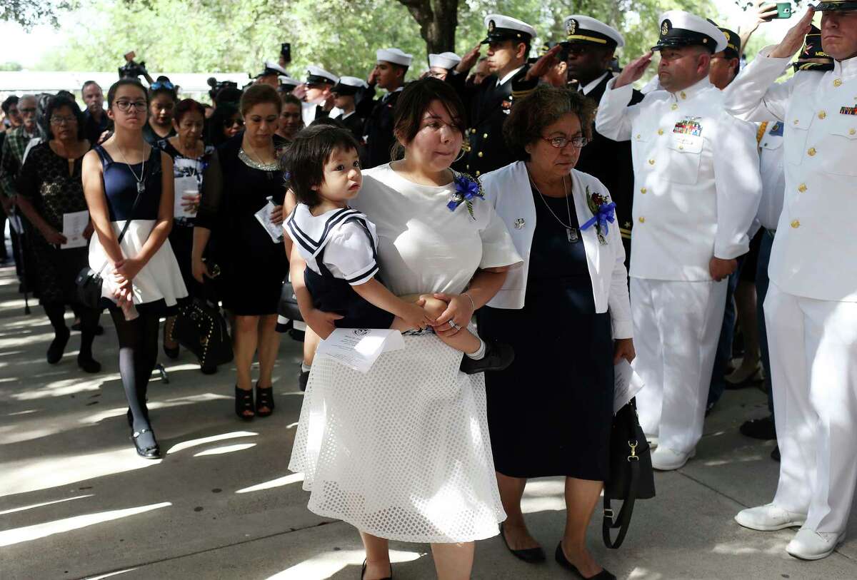 ﻿Noe Hernandez' family, including his wife, Dora, holding their﻿2-year-old son, Leon, and his mother, Virginia Yolanda Hernandez Lozano arrive for his burial services. ﻿