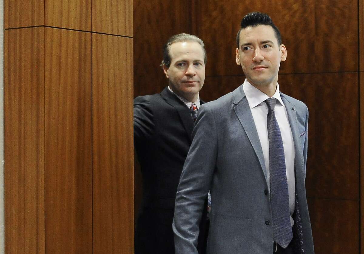 FILE - In this April 29, 2016, file photo, David Robert Daleiden, right, with attorney Jared Woodfill leave a courtroom after a hearing in Houston. A federal judge deciding whether a fellow judge should disqualify himself from a lawsuit over an anti-abortion group's videos says he could not readily discern any appearance of bias. U.S. District Court Judge James Donato said Thursday, June 22, 2017, he was having trouble understanding how Judge William Orrick's affiliation with a non-profit and two Facebook "likes" by Orrick's wife created an appearance of bias against defendant David Daleiden. (AP Photo/Pat Sullivan, File)