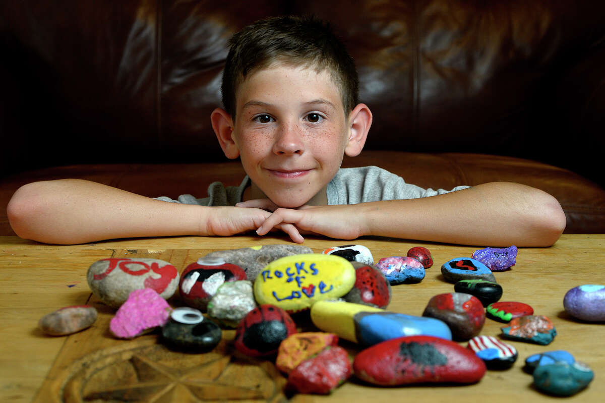 Bertis Whitehead, 11, has been painting rocks for his Rocks of Love project to pay for his grandmother's funeral. Whitehead has raised over $1,000. Photo taken Wednesday 7/5/17 Ryan Pelham/The Enterprise