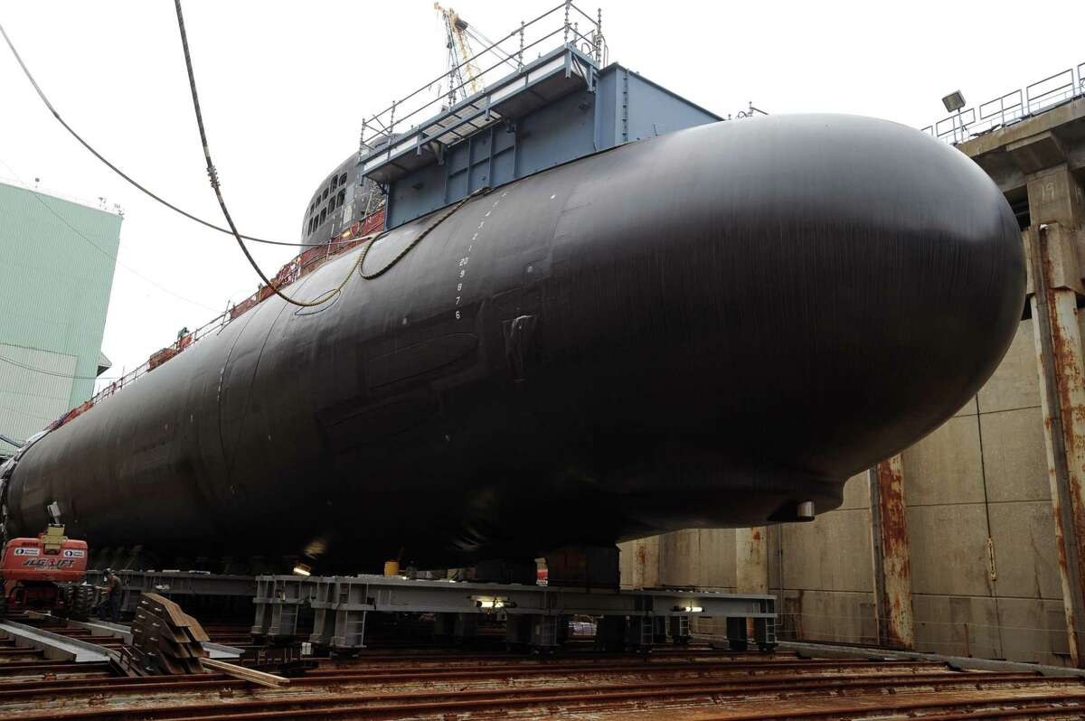 Shipyard workers at General Dynamics Electric Boat prepare a submarine for float-off in Groton in 2015.