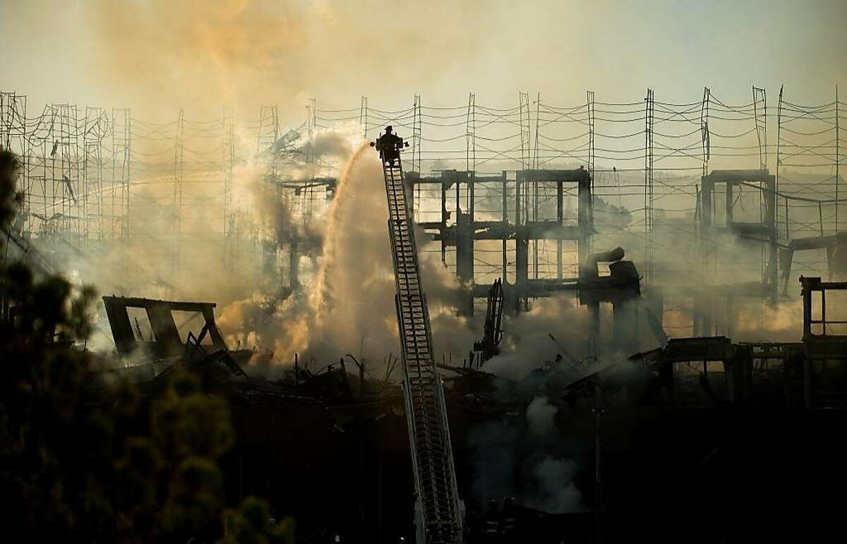 Firefighters battle a building fire at Valdez and 23rd Streets in Oakland, Calif., on Friday, July 7, 2017.