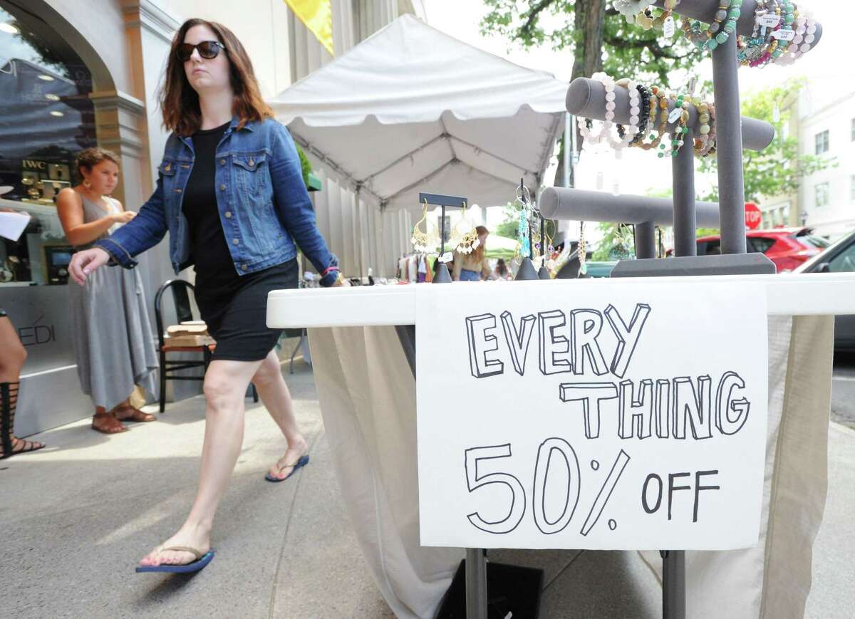 "Everything 50% Off," reads the sign attached to the Shun Mie Jewelry table during the Greenwich Sidewalk Sale Days on Greenwich Avenue, Greenwich, Conn., Thursday afternoon, July 10, 2014. The 2017 event will be held Thursday, July 13, to Saturday, July 15, from 10 a.m. to 6 p.m. and Sunday, July 16, from 11 a.m. to 5 p.m.