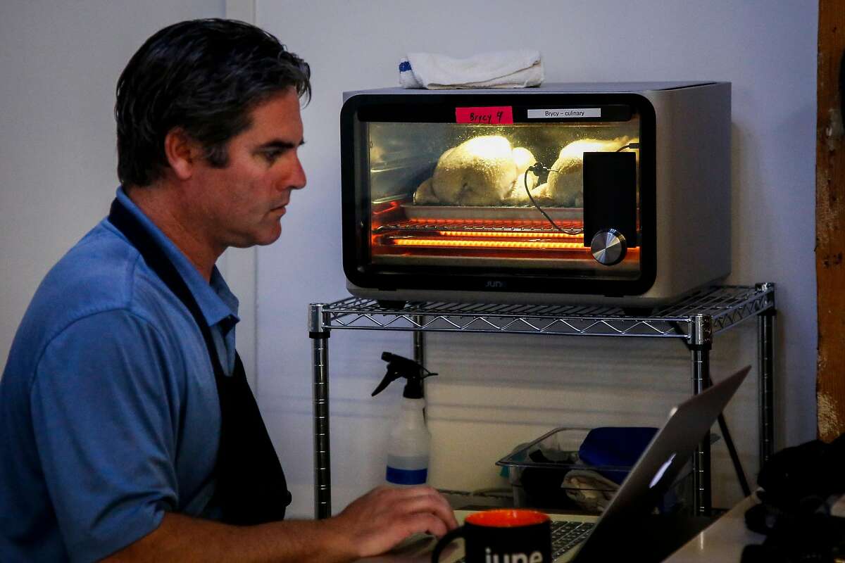 Henry Portner, culinary associate, works on programing cook cycles for chicken in the June offices in San Francisco on Thursday, July 6, 207. The June Intelligent Oven detects what food is placed into it and how long it should be cooked.
