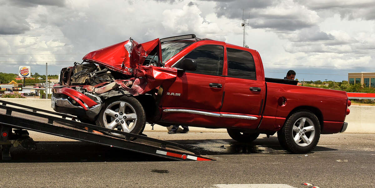 A severely damaged Dodge Ram rests on the side of IH 35 on Friday, July 7, 2017 after being involved in an accident with a black Ford F-150.