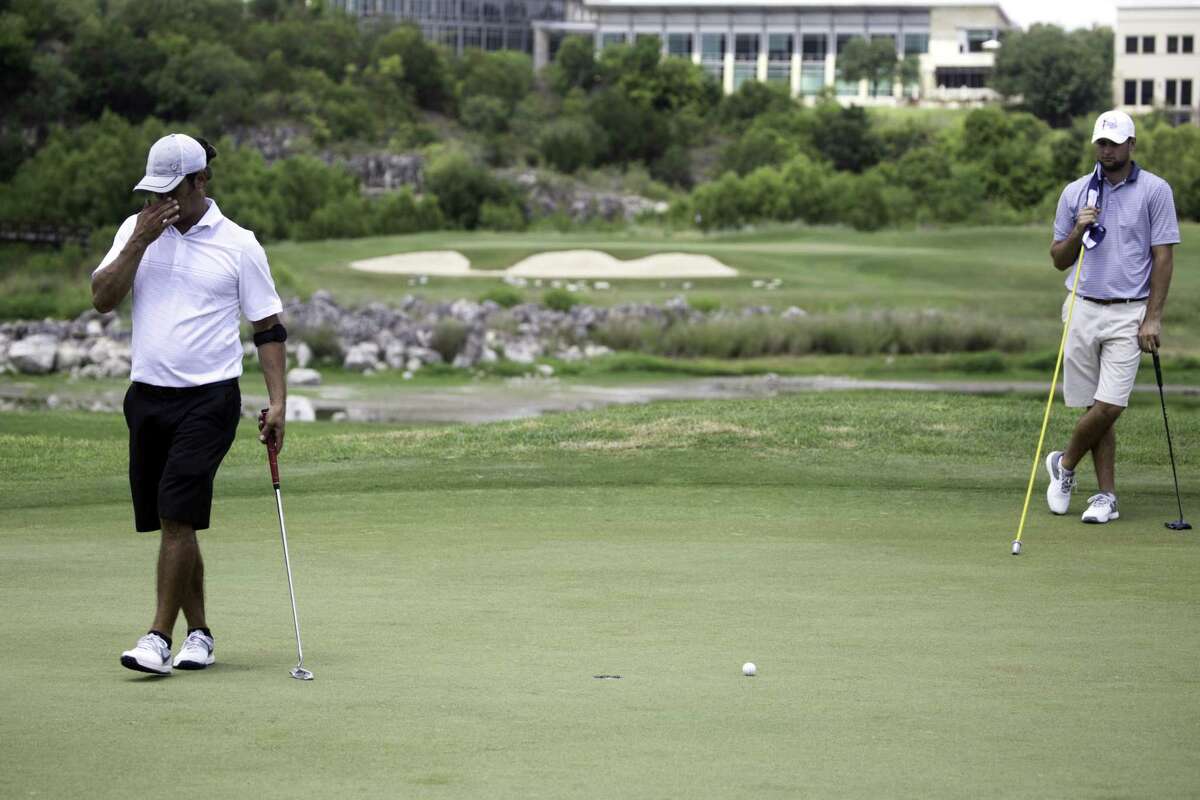 Chadwick Jones, left, is in disbelief after missing a putt as Redmond Lyons looks on. The Greater San Antonio Men's Championship kicked off round 1, Saturday, July 7, 2017, at the Quarry Golf Club.