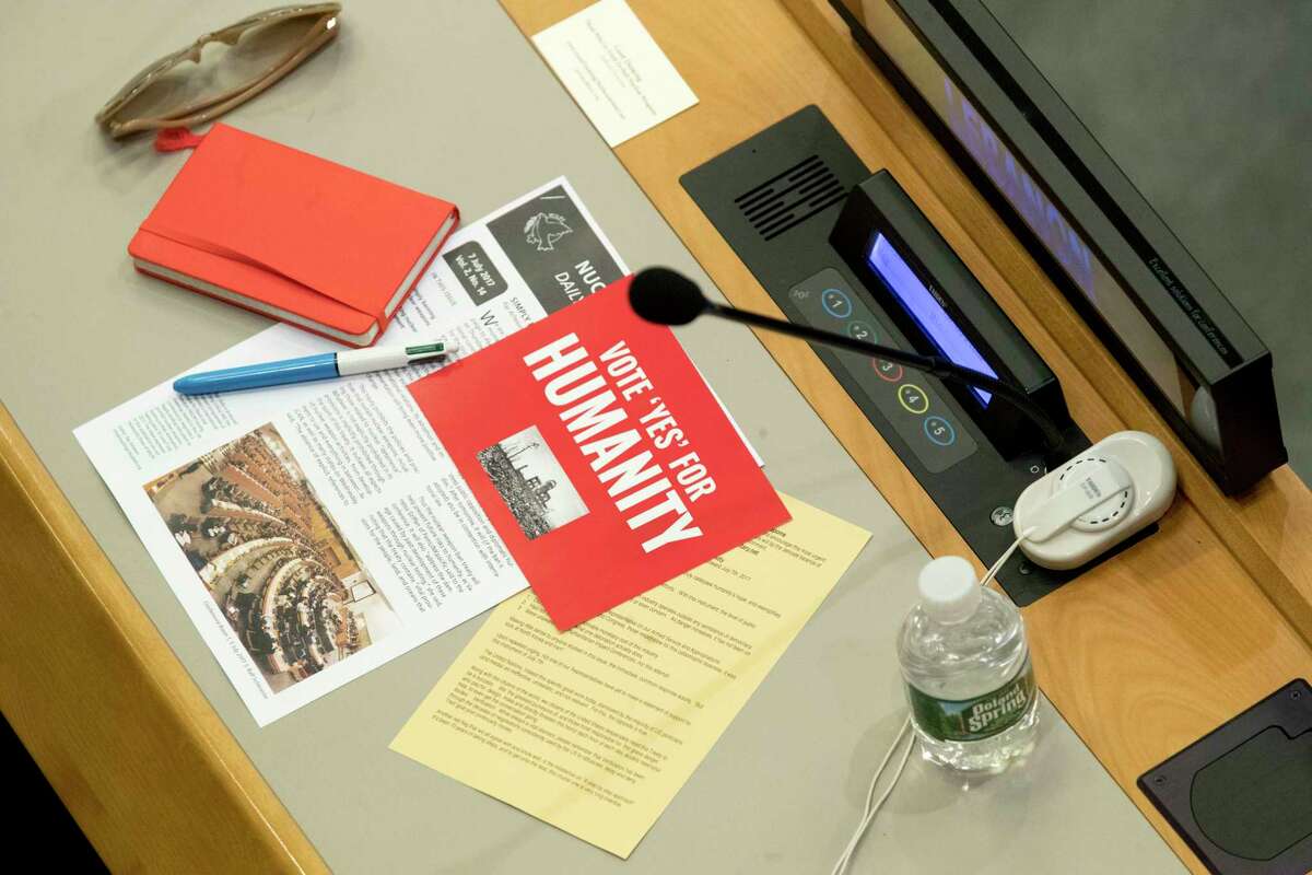 Leaflets are seen on a delegates desk before a vote by the conference to adopt a legally binding instrument to prohibit nuclear weapons, leading towards their total elimination, Friday, July 7, 2017 at United Nations headquarters. More than 120 countries have approved the first-ever treaty banning nuclear weapons at a U.N. meeting boycotted by all nuclear-armed nations. Friday's vote was 122 countries in favor with the Netherlands opposed and Singapore abstaining.(AP Photo/Mary Altaffer)