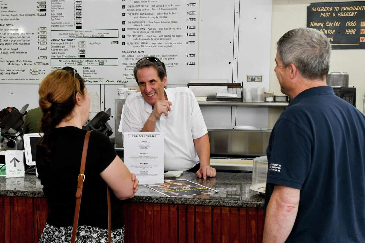 Fred Kaskowitz talks to customers Rosanne Johnson and her husband, Len Johnson, at Woods End Deli.