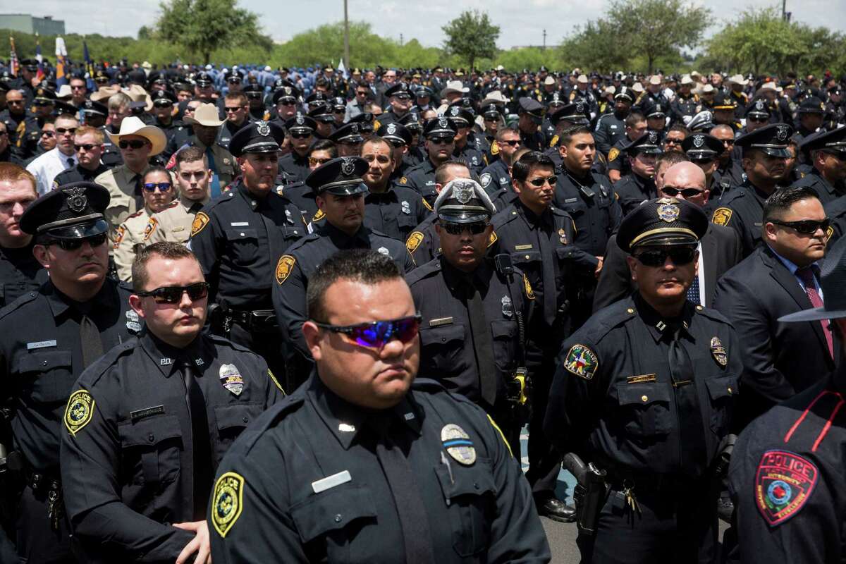 Officers with the San Antonio Police Department and other departments from across the state wait during the funeral for Officer Miguel Moreno III, who was killed in the line of duty, at the Community Bible Church in San Antonio, Texas on July 7, 2017.